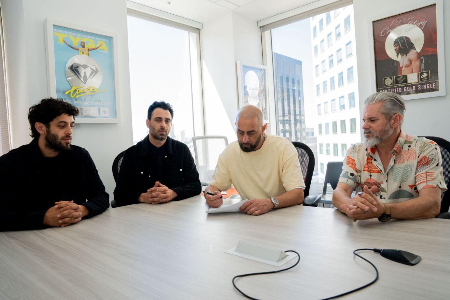 Ghazi Shami signs an agreement seated next to EMPIRE CPO Stephen White, and co-founders of Nebula Yamen Hawit and Fuad Hawit.